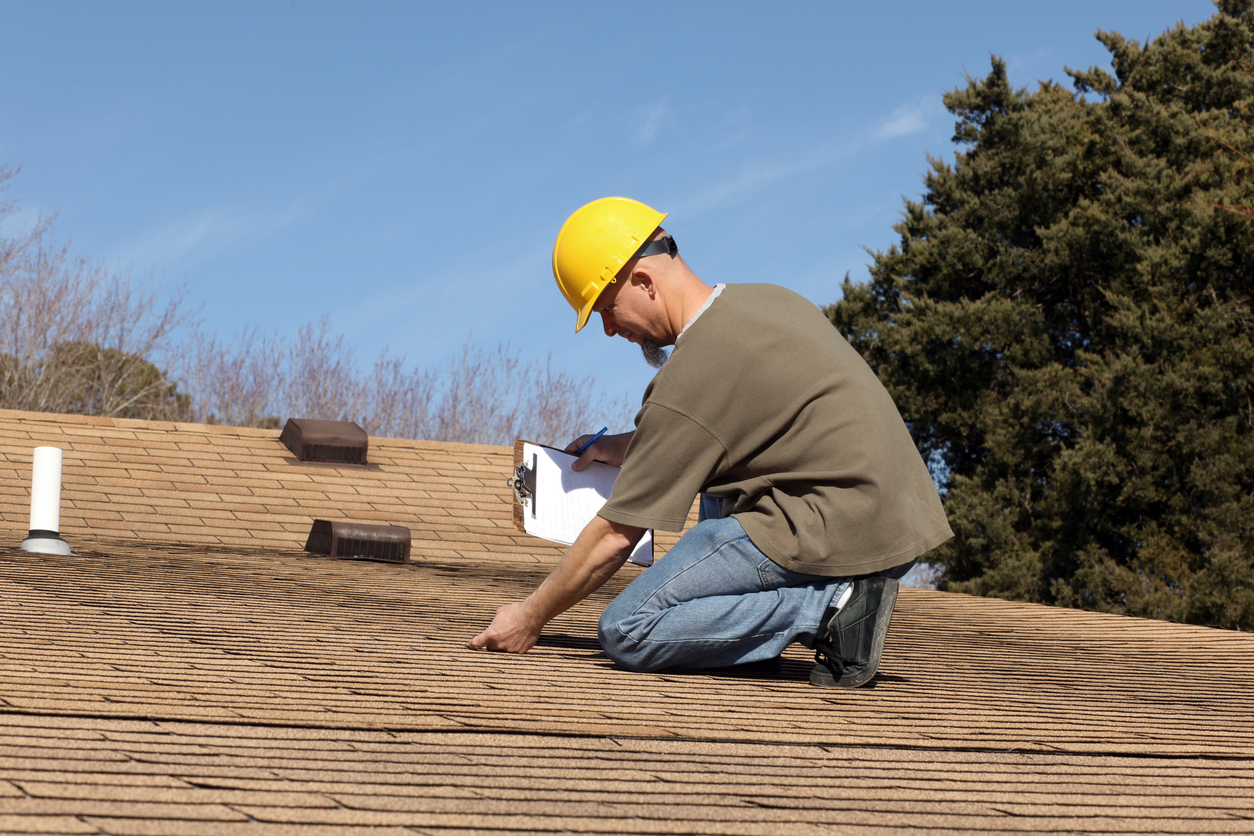 Licensed roof inspector performing maintenance check on a Kissimmee FL residential roof