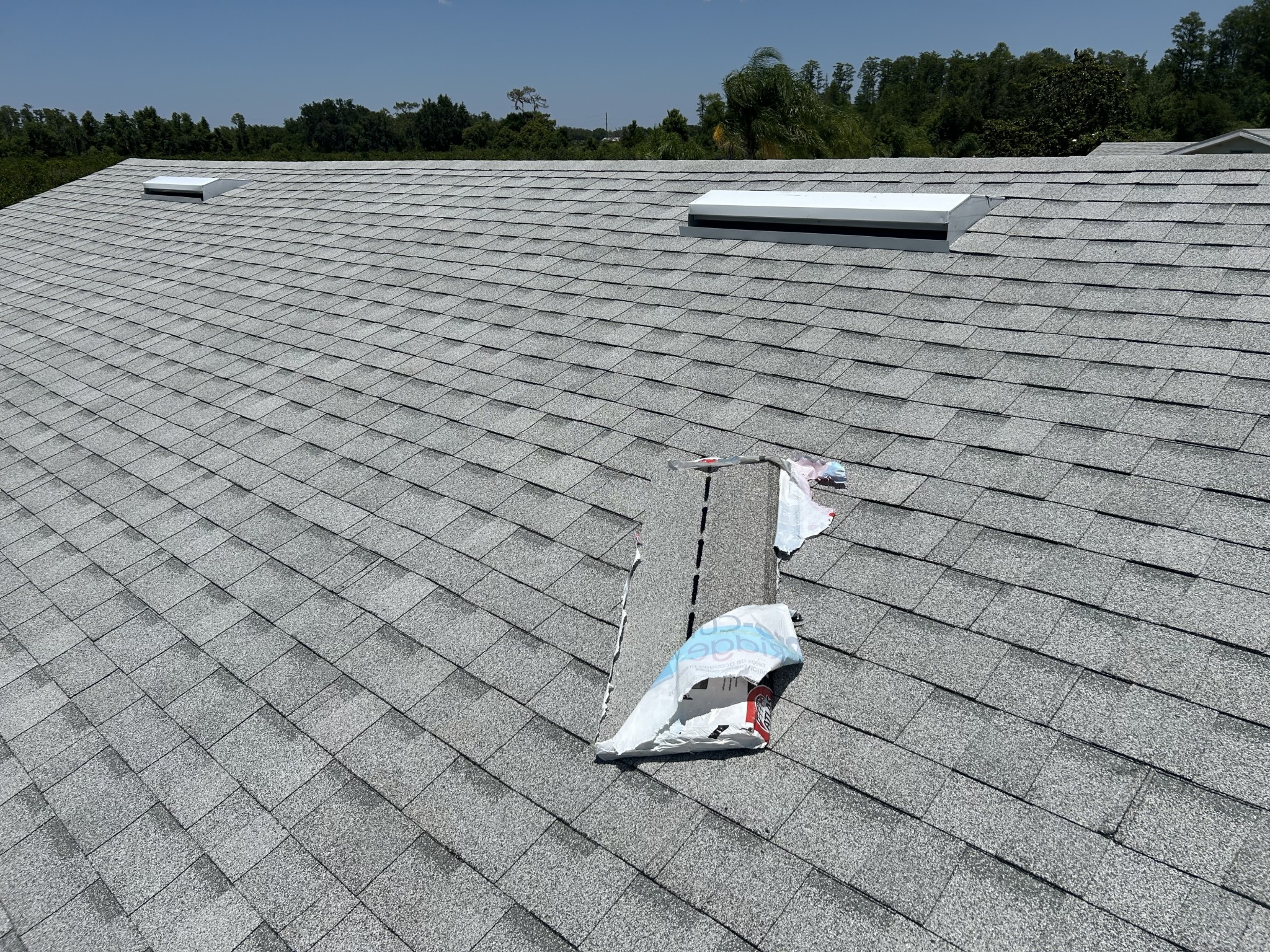 Professional roof repair crew fixing leak damage on a residential home in Kissimmee FL