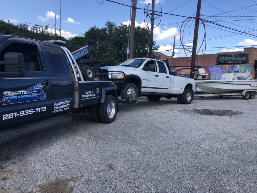 Flatbed tow truck loading a car for transport in Katy TX